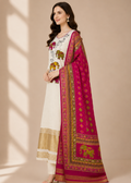 Woman wearing a traditional outfit with a white kurta, pink dupatta, and embroidered patterns on a beige background.