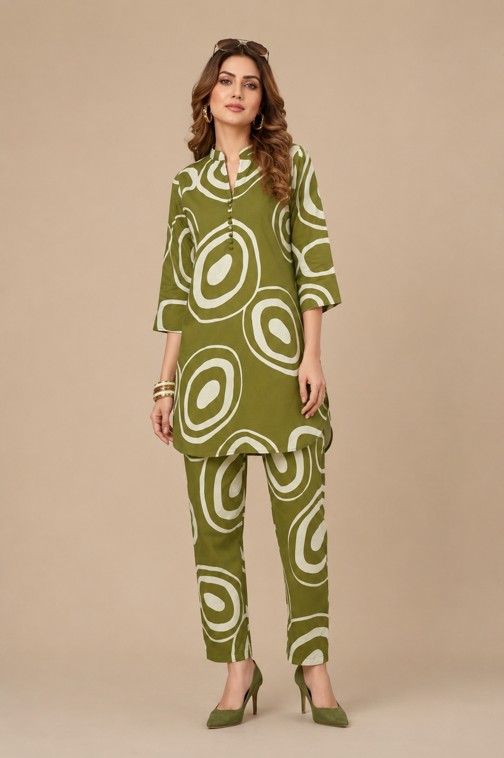 Woman wearing a green and white patterned outfit on a beige background