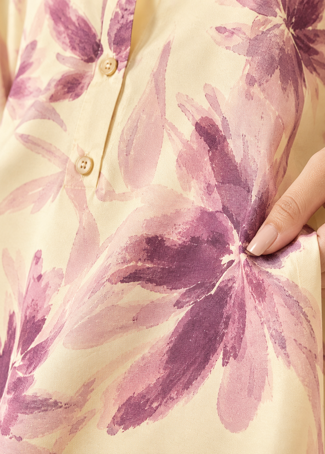 Close-up of a fabric with purple floral pattern on a beige background
