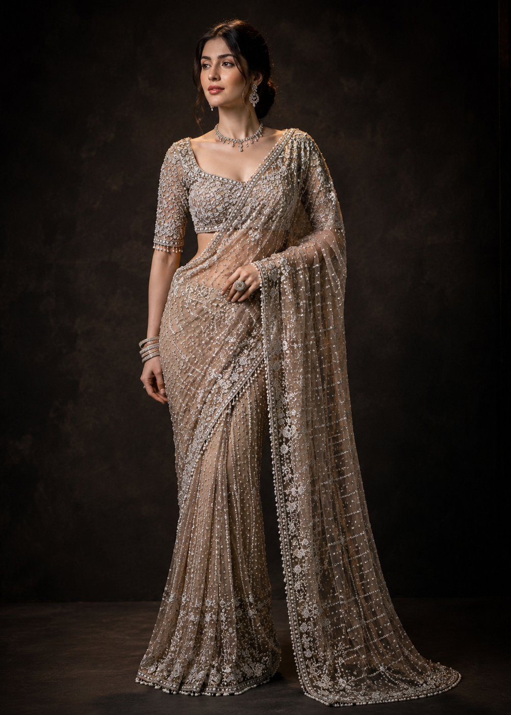 Woman wearing a sparkling saree against a dark background