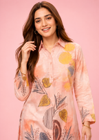 Woman wearing a floral pink shirt against a pink background