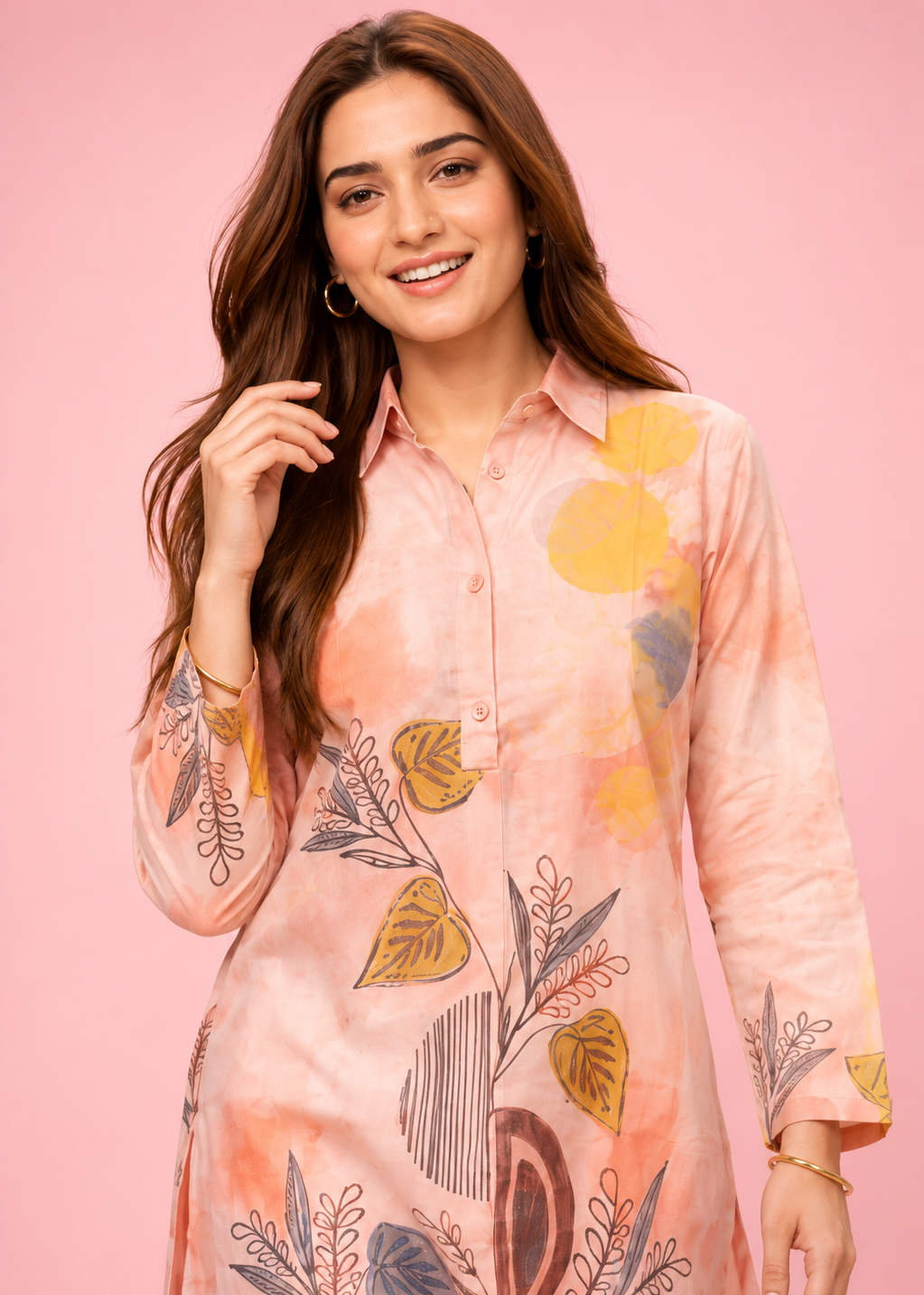 Woman wearing a floral pink shirt against a pink background