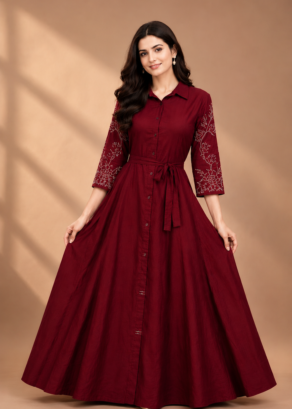 Woman wearing a burgundy dress with floral patterns on a brown background