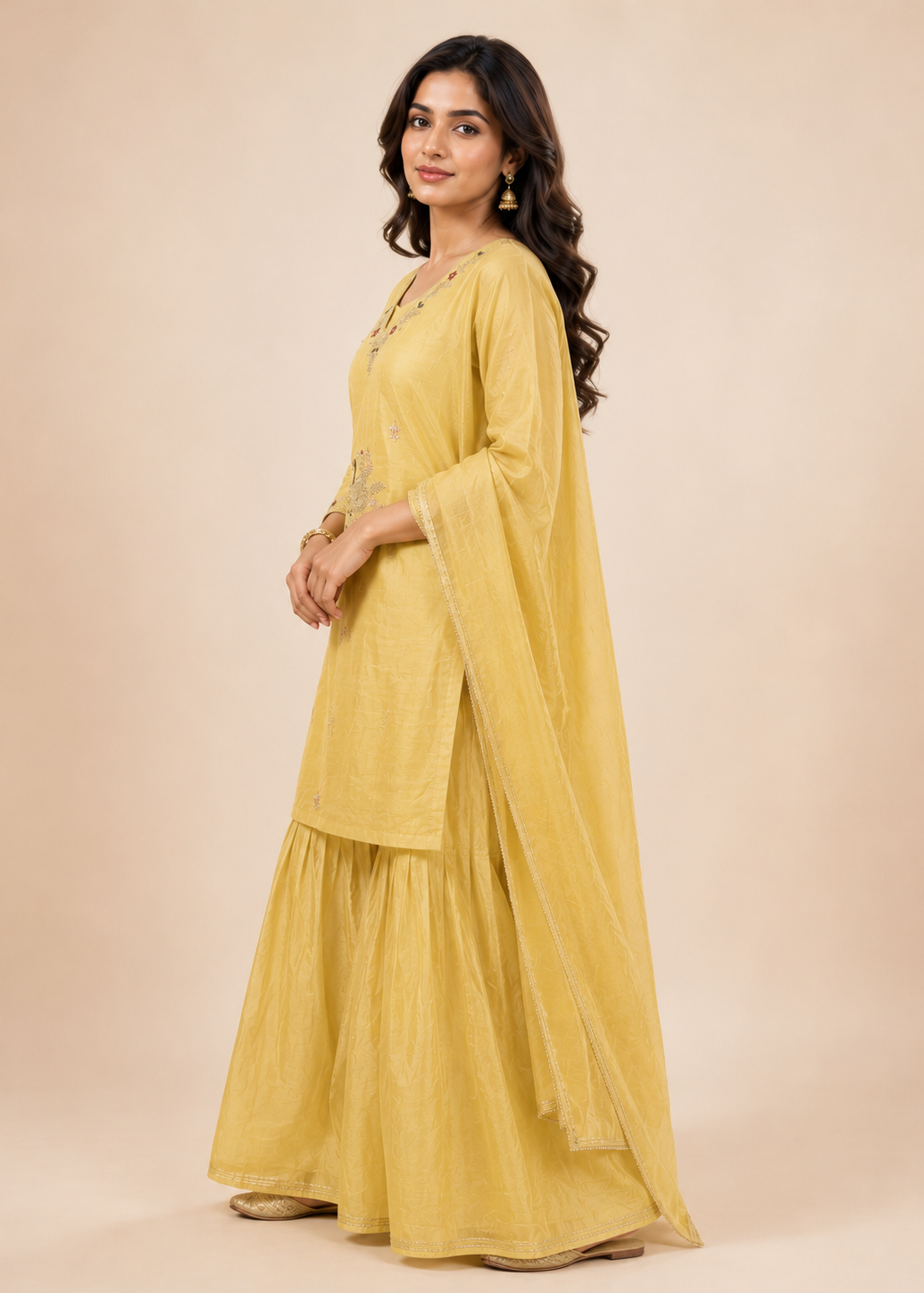 Woman wearing a yellow traditional outfit with a beige background