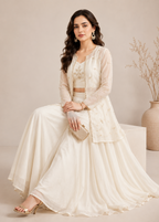 Woman in a cream traditional outfit with a neutral background