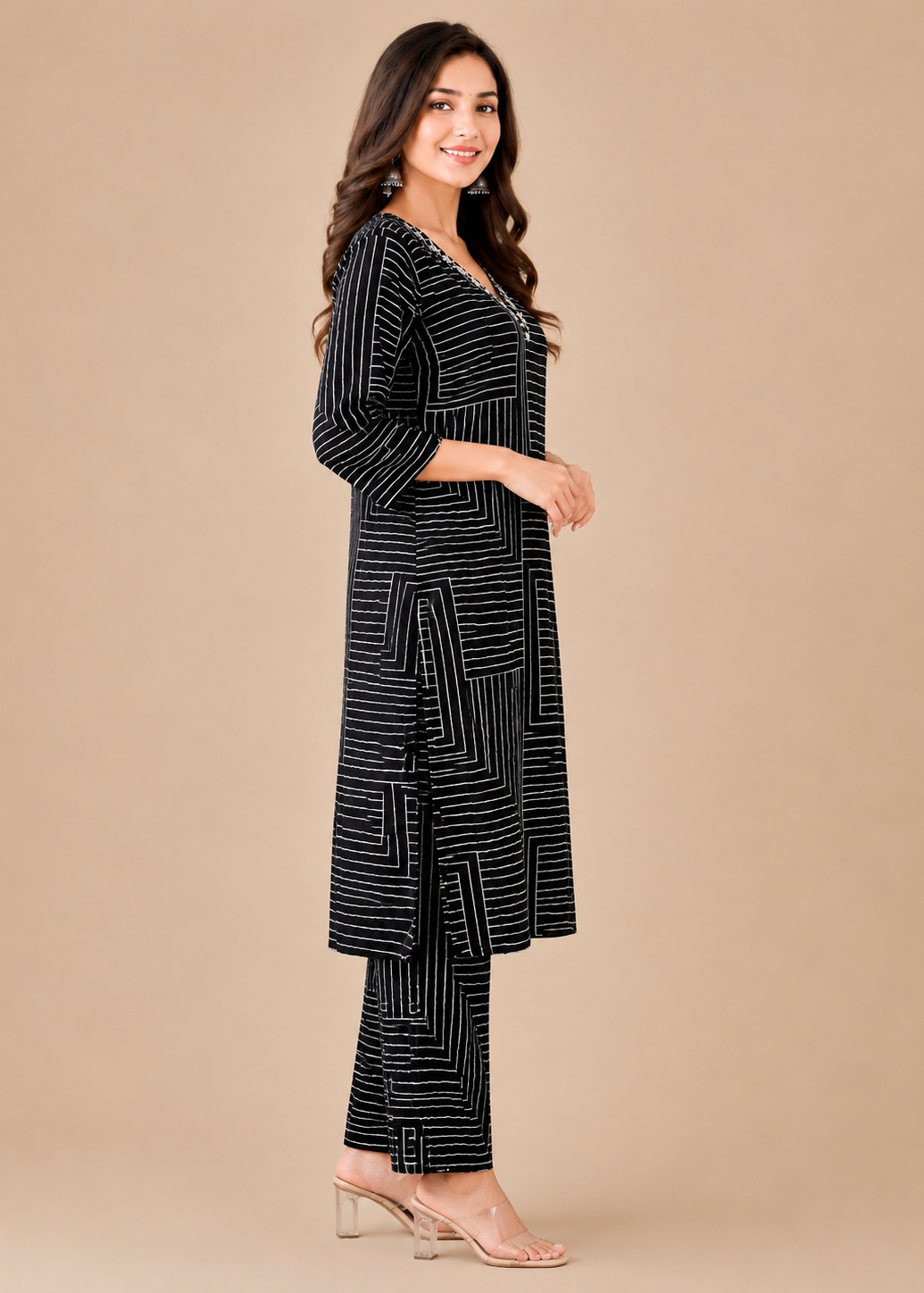 Woman wearing a black and white patterned outfit on a beige background