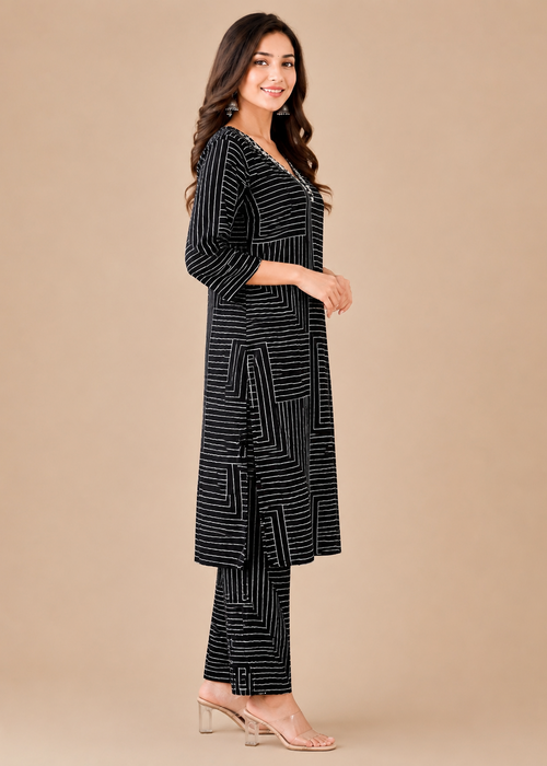 Woman wearing a black and white patterned outfit on a beige background