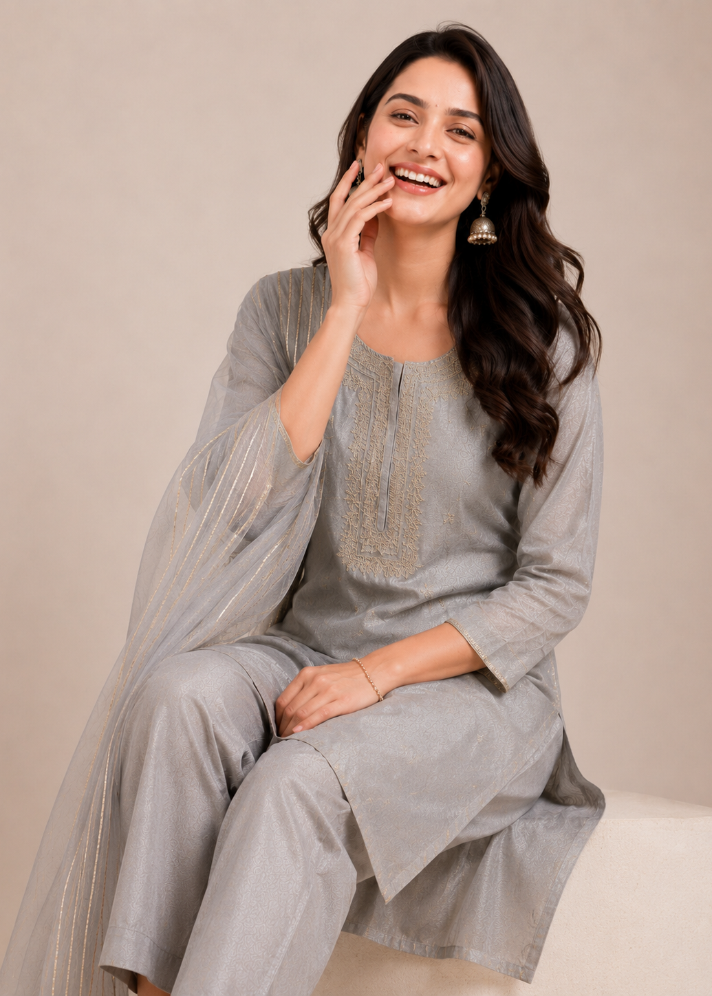 Woman wearing a gray traditional outfit with a plain background