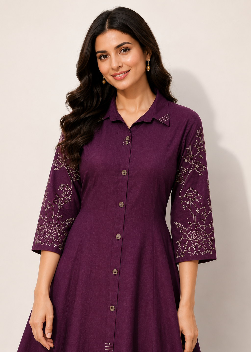 A woman wearing a purple button-front kurta dress with three-quarter sleeves and white floral embroidery on the sleeves, photographed against a plain light background.