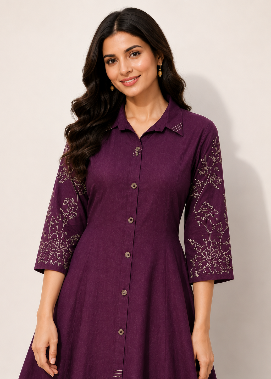 A woman wearing a purple button-front kurta dress with three-quarter sleeves and white floral embroidery on the sleeves, photographed against a plain light background.