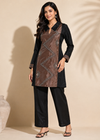 A woman models a black and brown kurta set with matching wide-leg pants. The kurta features a brown front panel with silver geometric embroidery, and black sleeves and side panels.