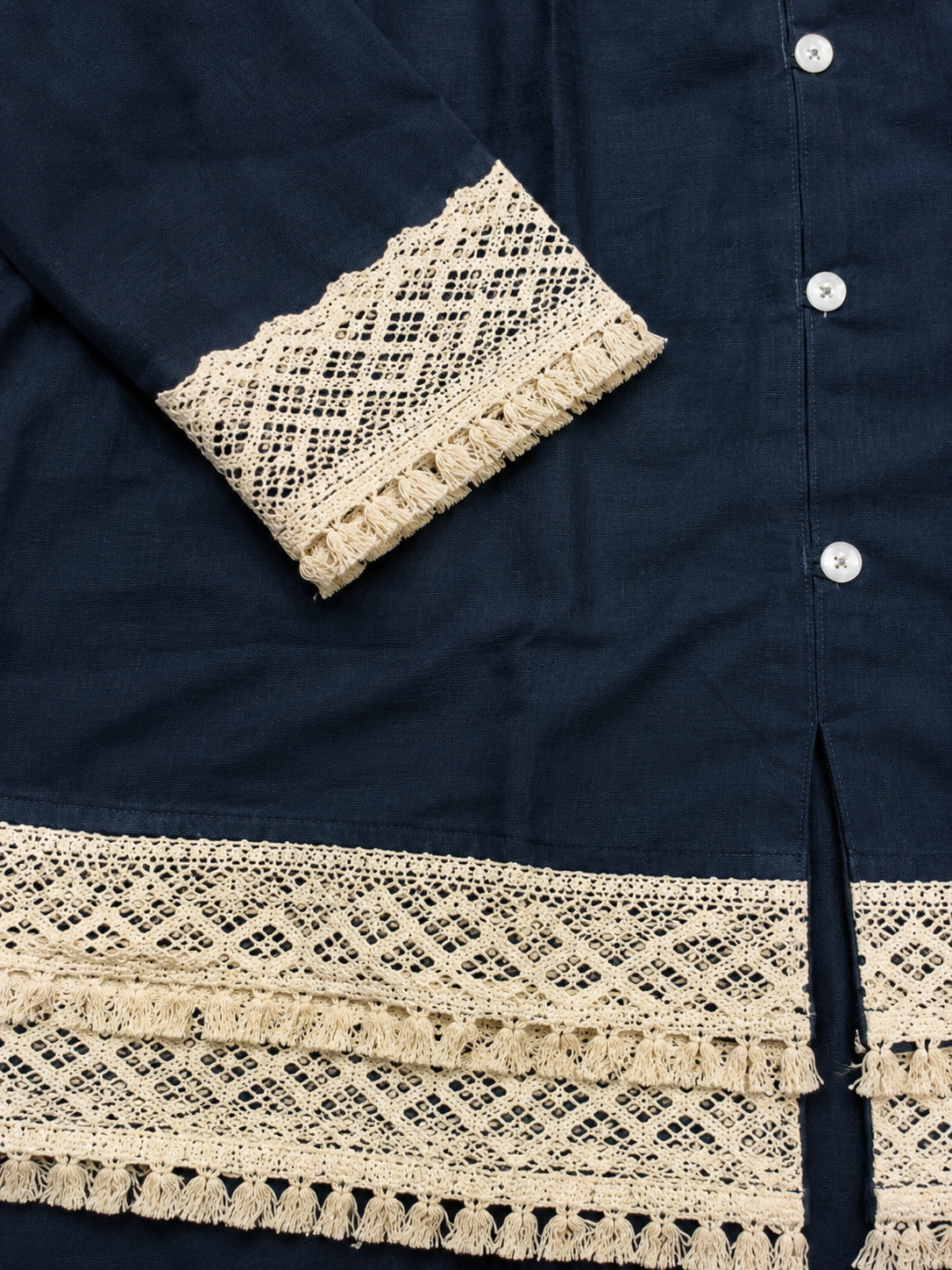 Navy blue shirt with beige lace details on cuffs and hem