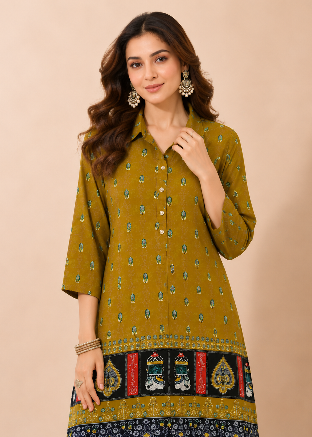 A woman modeling a mustard yellow kurta with small blue and green floral prints and a decorative border at the hem, set against a solid beige background.