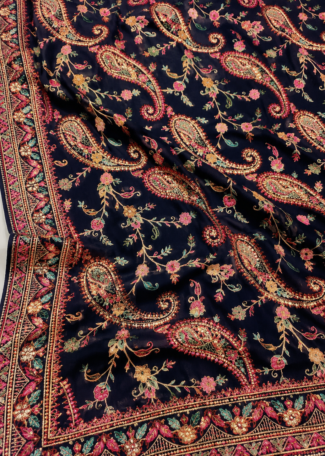 Close-up of a patterned fabric with paisley designs on a dark background