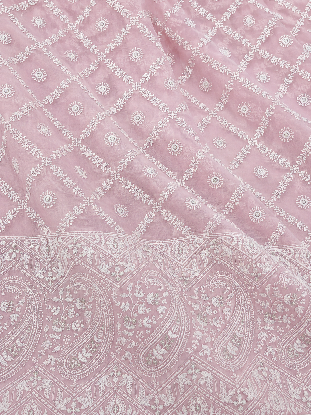 Pink fabric with white paisley pattern