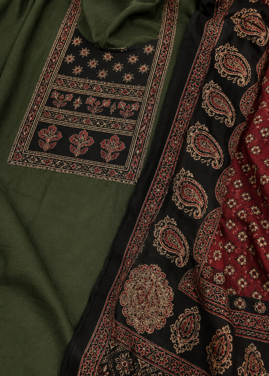 Traditional embroidered fabric with intricate patterns on a green and red background