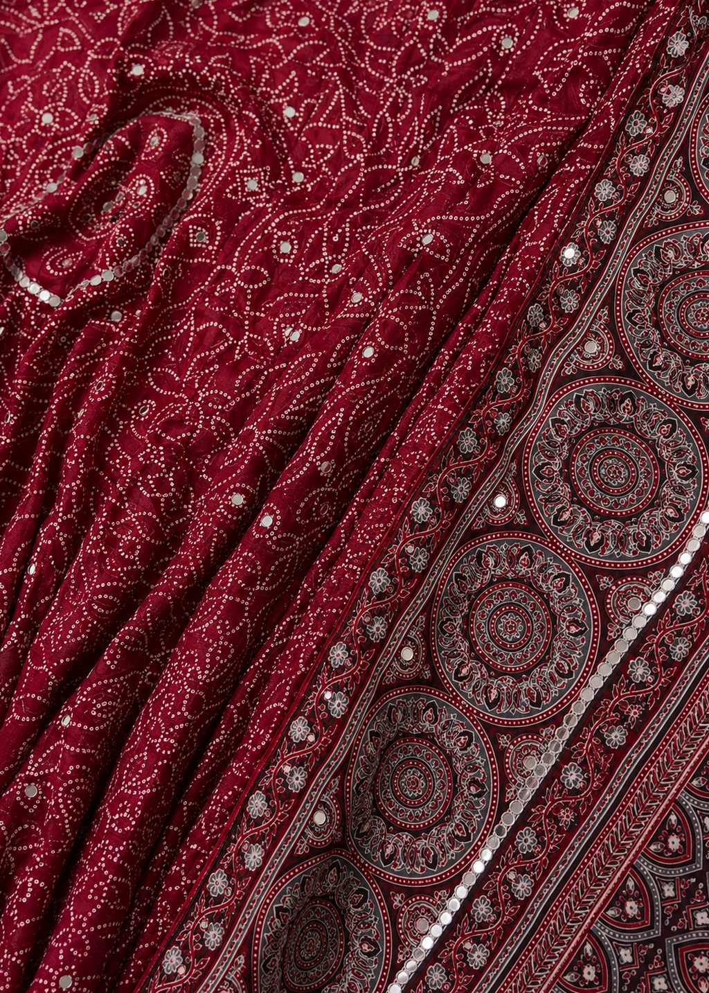 Close-up of a red fabric with intricate patterns and embellishments