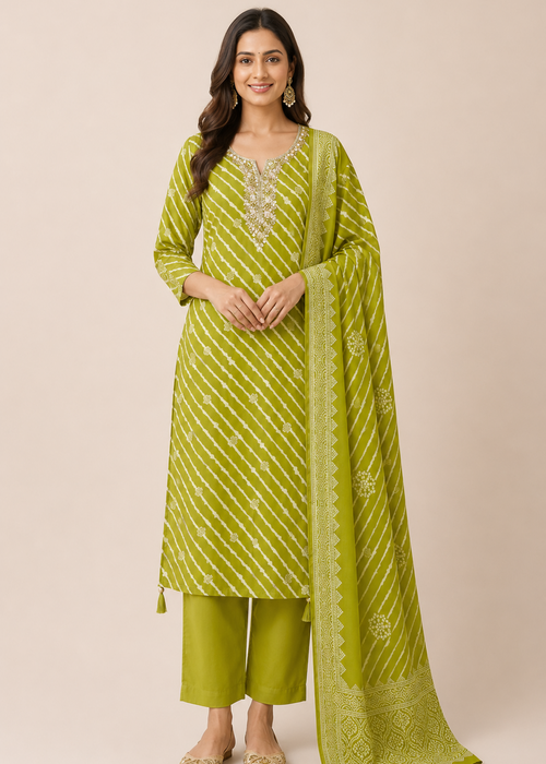 A woman modeling a lime green traditional Indian salwar kameez suit with matching dupatta. The kurta features vertical diagonal stripes and silver mirror work embroidery on the neckline, paired with matching green trousers and a coordinating patterned dupatta, set against a solid beige background.