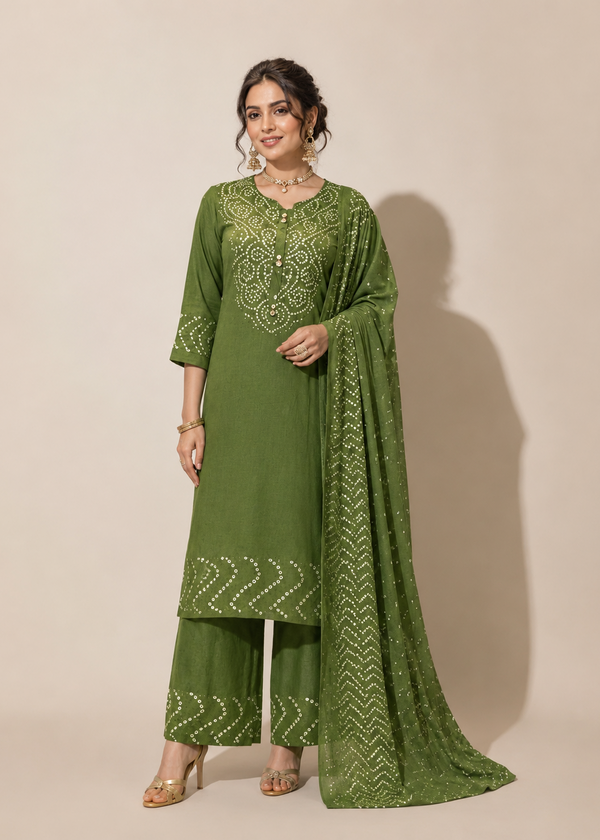 A woman models a green ethnic salwar kameez suit with matching palazzo pants and a dupatta, featuring white printed patterns and embroidery on the neckline, set against a plain beige background.