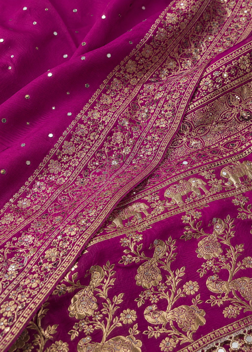 Close-up of a purple fabric with gold embroidery and embellishments